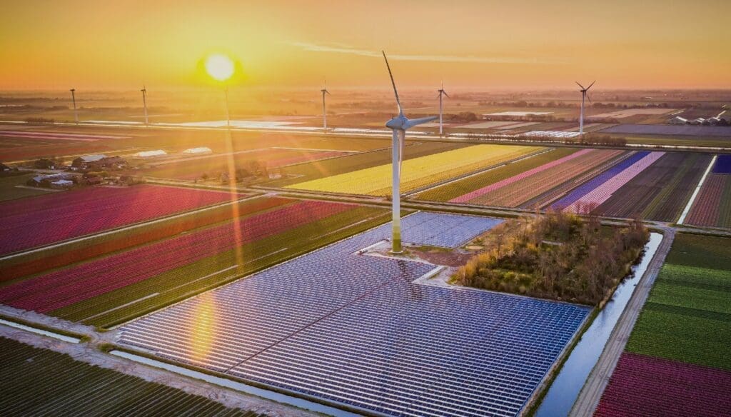 Solar energy and windmills on landscape with sunset - RA-ESG